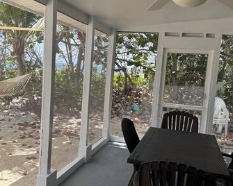 Private 2-b beachfront cottage w/ hammocks, screened-in veranda, sunsets & more! - Cayman Brac - Patio