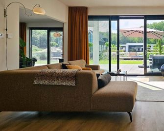 Luxury villa with veranda, canoe - Zeewolde - Living room