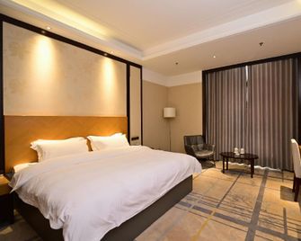 Shuiyi Jianianhua Hotel - Heze - Спальня