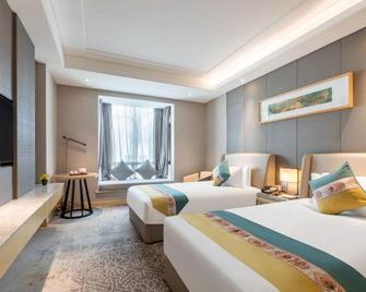 Shiyan Jiahua Holiday Hotel (Wuyan Shopping Mall People's Hospital Branch) - Shiyan - Schlafzimmer