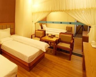 Baoxin Business Hotel - גואנגג'ואו - חדר שינה