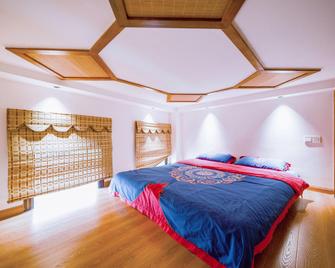 Hansu Exotic Inn (Zhangjiajie Wulingyuan Branch) - Zhangjiajie - Slaapkamer