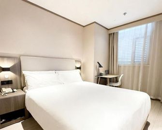 Hanting Hotel Tianjin Jinnan Development Zone National Exhibition Center - Tianjin - Bedroom