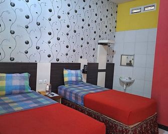 Ria Hotel Jember - Jember - Slaapkamer