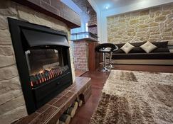 Modern Oasis with a Cozy Fireplace Your Stylish Apartment Minutes from Downtown - Bucharest - Living room