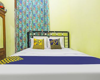 Hotel O Desa Wisata Nangelasarinearpasir Tulang - Tasikmalaya - Bedroom