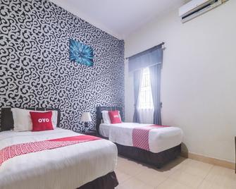 Capital O 91431 Hotel Ratama Syariah - Palangkaraya - Habitación