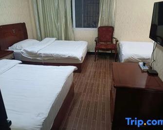 Dongnan Hotel - Xishuangbanna - Ložnice
