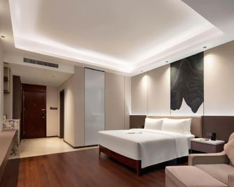 Meijun International Hotel - צ'נגשה - חדר שינה