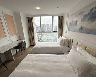 Magnificent International Hotel - Shanghai - Schlafzimmer