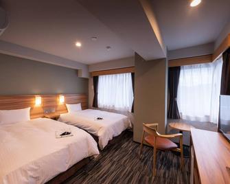 Central Hotel Takeoonsen Ekimae - Takeo - Bedroom