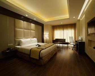 The Gulmohar Grand Hotel - Una - Bedroom
