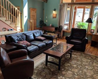 Gorgeous five bedroom home sleeps up to 13 guests. Extensive decks wrap the home, fishing pond, 11 acres with forest, pasture, and abuindance of wildlife. - Ashford - Living room