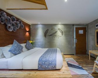Weiximan Holiday Hotel - קונמינג - חדר שינה