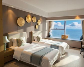 Lvfeng Holiday Apartment (Qingdao Convention and Exhibition Center) - Qingdao - Bedroom