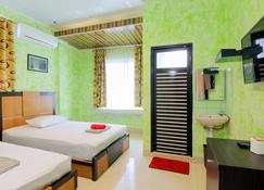 Yani Homestay - Padang - Schlafzimmer