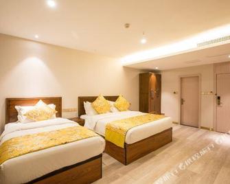 Chunqiu Hotel - Ťi-ning - Ložnice