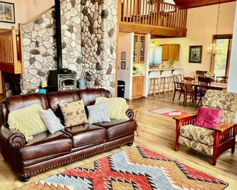 Dog-friendly cabin with large yard, wood stove, grill & mountain views - Pagosa Springs - Living room
