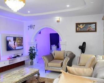 Uncle Love Serviced Apartments — A Modern and Relaxing 3-Bedroom Apartment - Akure - Living room