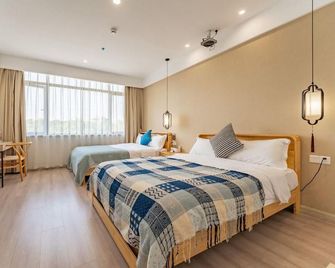 Suzhou Dao Xiang Impression Homestay (Cai Flower Sea Shop in Bei Tai Lake Tourist Vacation Area) - Suzhou - Bedroom