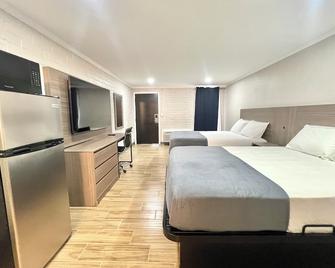 Economy Suites Extended Stay - Tulsa - Schlafzimmer
