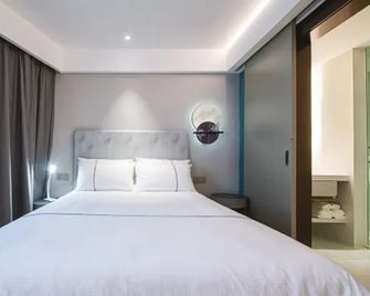 Magnotel Hotel Wuhan Jiangtan Lihuangpo Road Pedestrian Street - Wuhan - Soveværelse