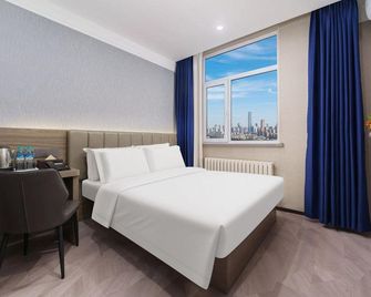 7 Days Inn Dalian Xian Road Business Center Xinggong Street Subway Station Branch - Dalian - Bedroom