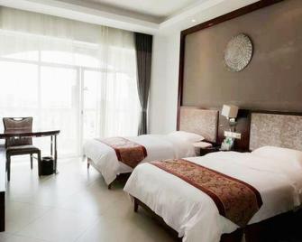 Hongda Hotel - Qionghai - Slaapkamer
