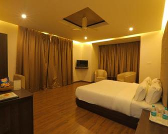 Hotel Vasundhara Palace - 瑞詩凱詩 - 臥室