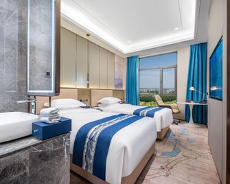 Zhangye Jiancheng Holiday Hotel - Zhangye - Schlafzimmer
