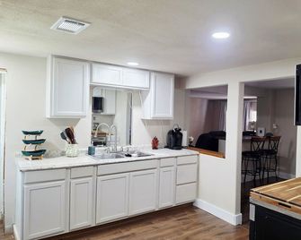 This charming 2/1, remodeled home features new floors, plumbing, & central air, - Breckenridge - Kitchen
