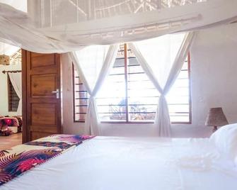 Capricorn Beach Cottages - Pangani - Habitación