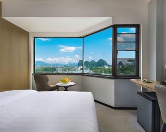 Universal international hotel (Guilin Liangjiang Sihu Elephant Trunk Mountain Branch) - غويلين - غرفة نوم