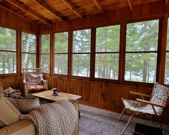 Rustic cabin in remote wooded area on point overlooking lake. - Bigfork - Living room