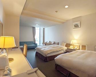 Hotel New Century - Okinawa - Schlafzimmer