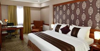 Abadi Suite Hotel & Tower - Jambi - Schlafzimmer