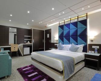 Hotel Pragati The Grand - Ahmedabad - Slaapkamer