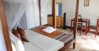 African Roots Guesthouse - Entebbe - Camera da letto