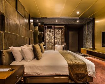 Bellus Inn - טאינאן - חדר שינה