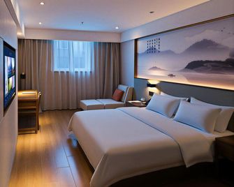 Taibai Restaurant Boutique Garden Hotel (West to Jining North Bus Station) - Jining - Bedroom