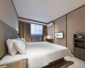 Hanting Hotel Zibo Railway Station - Zibo - Schlafzimmer