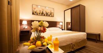 Grand Lily Hotel Suites - Hofuf - Schlafzimmer