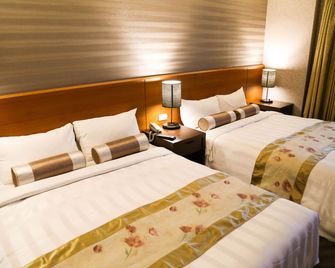 Unique Holiday Hotel - הואליין סיטי - חדר שינה