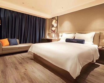 7 Days Premium Hotel (Heze Huanghe Road) - Heze - Спальня