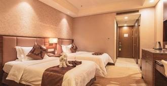 Xincheng Hotel - הוהוט - חדר שינה