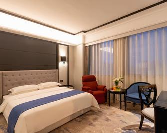 Xinhua Zhongzhou International Hotel - Zhengzhou - Slaapkamer