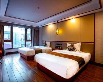 Yunshangpin International Hotel - Xishuangbanna - Bedroom