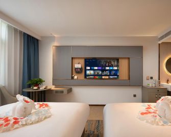 Wanning Xinglong Overseas Chinese Hotel (Xinglong Style Street Branch) - Wanning - Bedroom