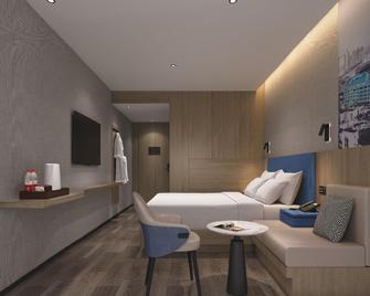 Qi Tian Hotel (Xinhua Railway Station) - Loudi - Bedroom