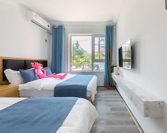 Qingdao Wulan Tingyue Seaview Villa (Wusi Square Olympic Sailing Center Shop) - Qingdao - Schlafzimmer
